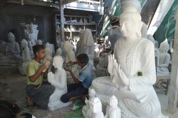 Facial features being applied to statues in Mandalay