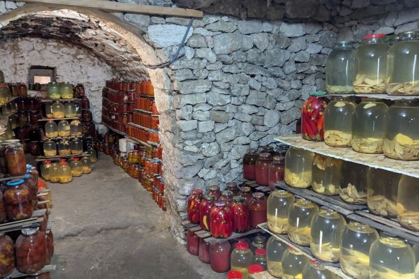 Jars of Moldovan pickled cucumbers, tomatoes, apples, and watermelon