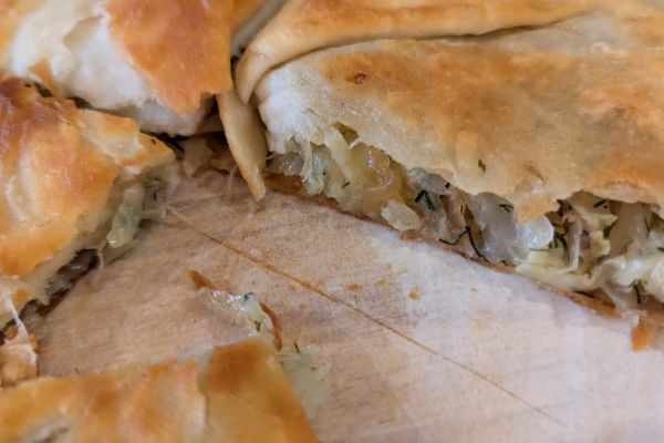 Freshly baked Moldovan plăcinte pastries filled with meat