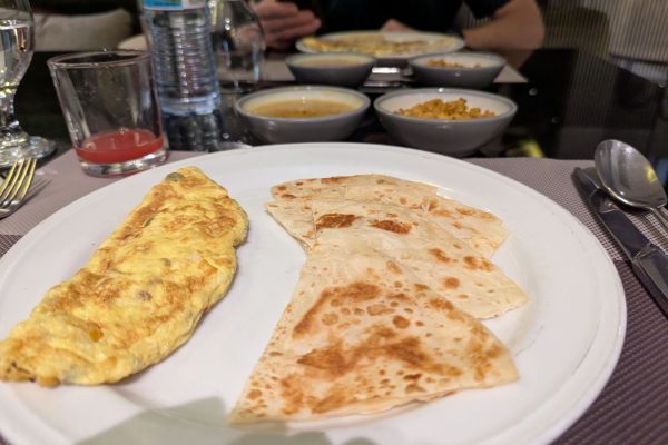 Omlette and paratha breakfast at Omni Residency
