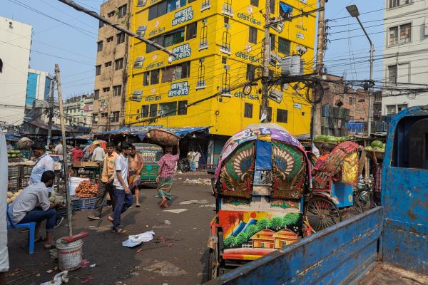 Rickshaws and man walking in old Dhaka