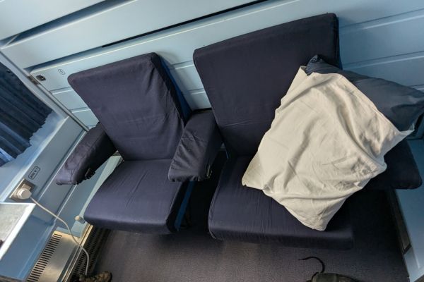 Seating folds to bed on private two berth cabin Kazakhstan Train